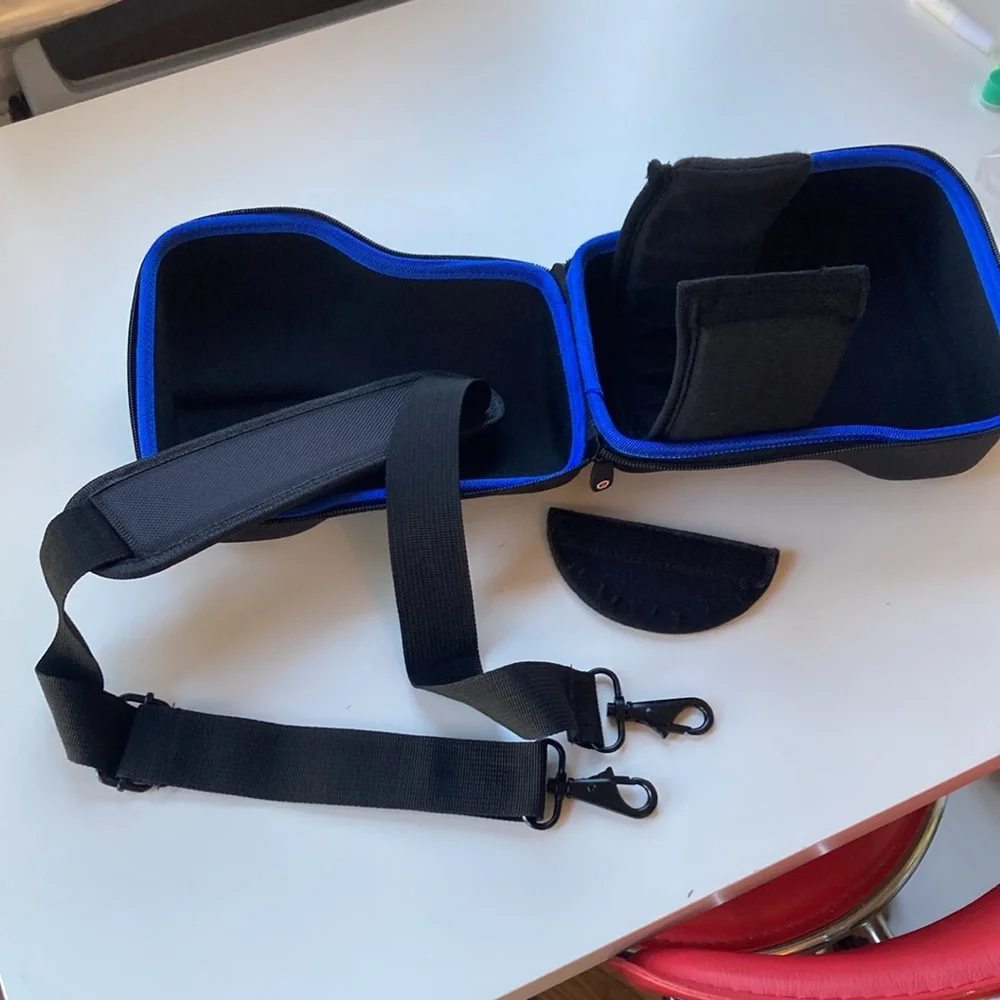 Hard carrying case for long-lens camera with strap